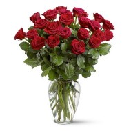 Two dozen roses in a glass vase
